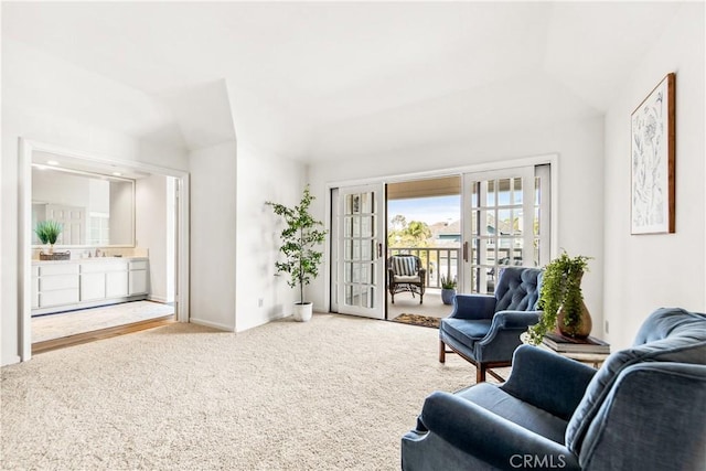 living area featuring carpet floors and french doors