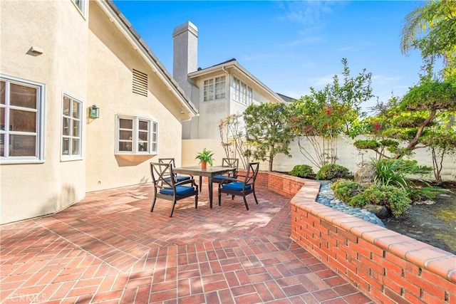 view of patio with outdoor dining space and a fenced backyard