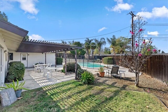 view of yard featuring a pergola, a fenced in pool, and a patio area