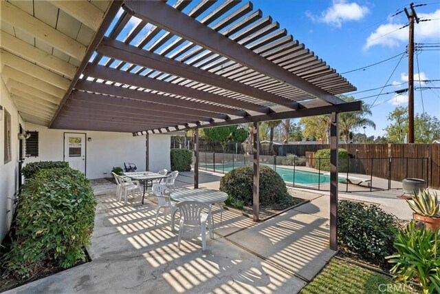 view of patio / terrace featuring a fenced in pool and a pergola