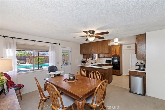 dining room featuring ceiling fan and a textured ceiling