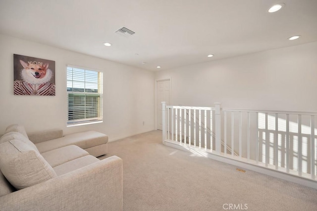 sitting room featuring light carpet