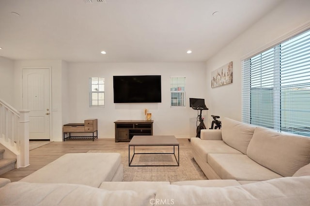 living room with a healthy amount of sunlight and light hardwood / wood-style floors