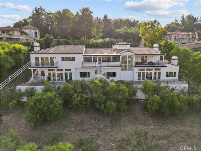 rear view of property with a balcony