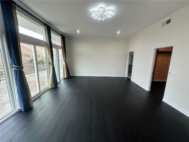 empty room with dark wood-type flooring and ornamental molding