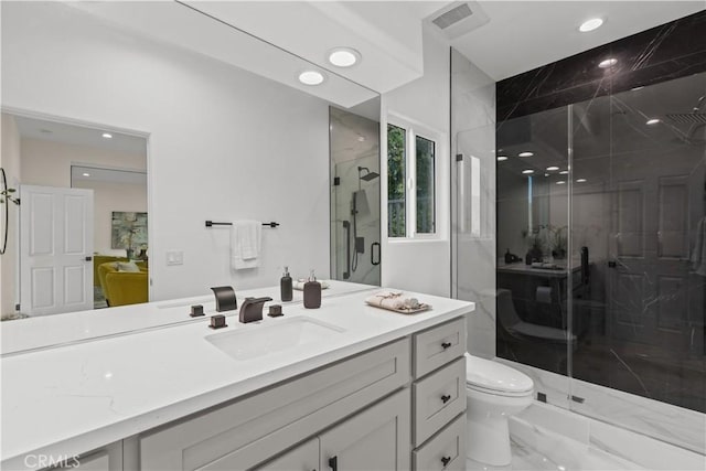 bathroom featuring walk in shower, vanity, and toilet