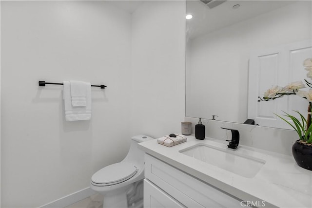 bathroom featuring vanity and toilet