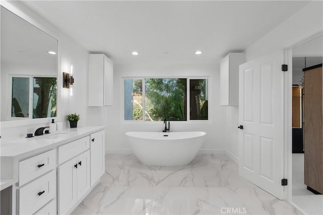 bathroom featuring vanity and a bathing tub