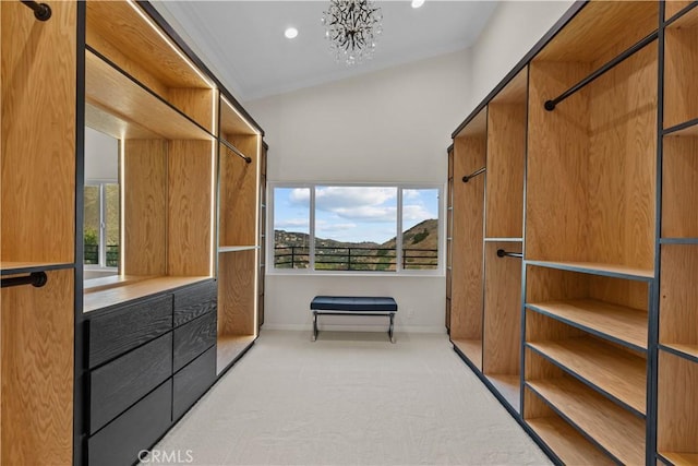 walk in closet featuring light carpet and a notable chandelier