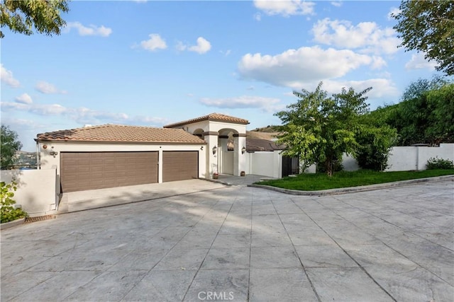 mediterranean / spanish home with a garage