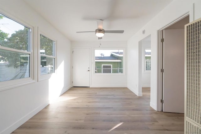 corridor with light hardwood / wood-style flooring