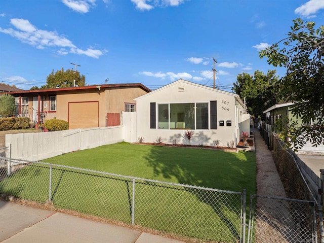 manufactured / mobile home with a garage and a front lawn