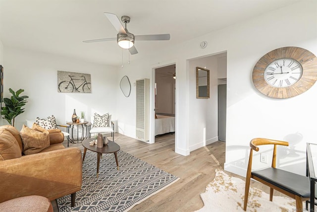 living room featuring ceiling fan and light wood-type flooring