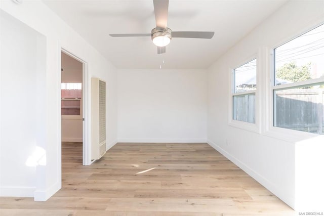 empty room featuring ceiling fan and light hardwood / wood-style flooring