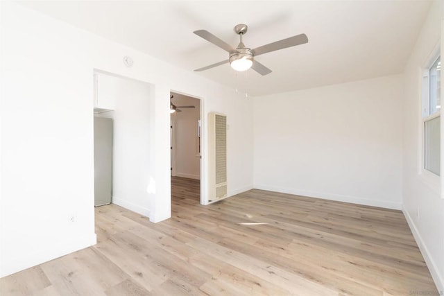 empty room featuring ceiling fan and light hardwood / wood-style floors