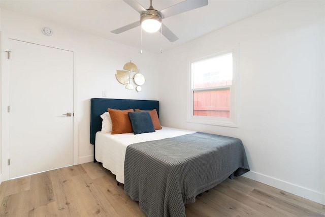 bedroom with ceiling fan and light hardwood / wood-style flooring