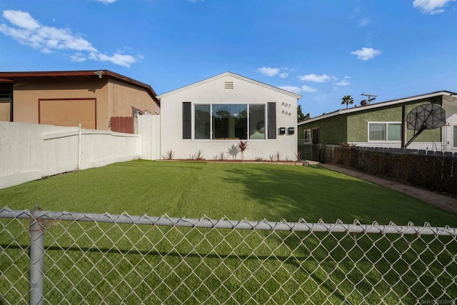 back of house with a yard