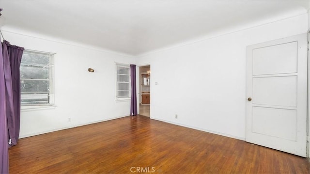 unfurnished room with hardwood / wood-style floors