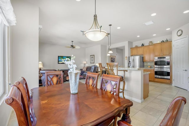 tiled dining room featuring ceiling fan