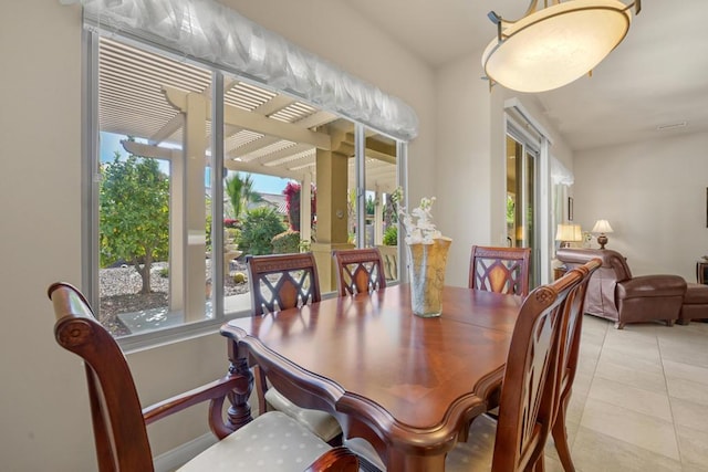 dining space featuring light tile patterned floors