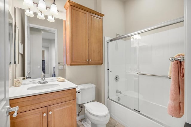 full bathroom with toilet, vanity, and shower / bath combination with glass door