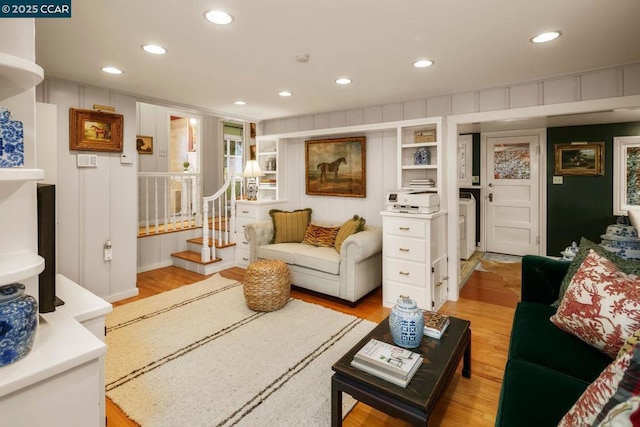 living room with washer / dryer and light wood-type flooring