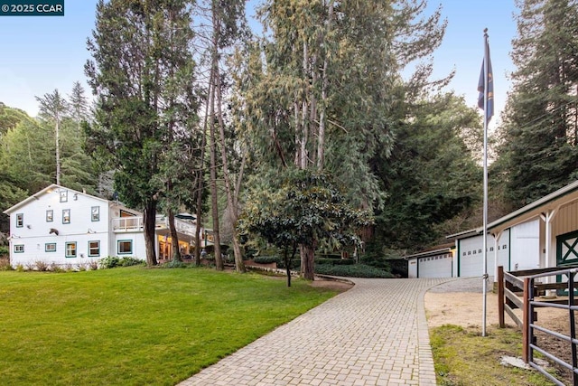 view of front of property with a garage and a front lawn