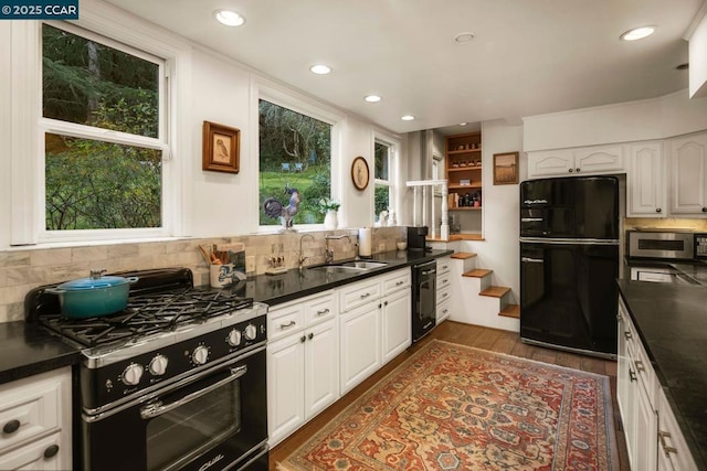 kitchen featuring sink, black appliances, dark hardwood / wood-style flooring, white cabinets, and backsplash