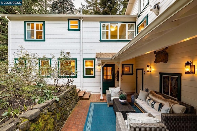 back of house featuring outdoor lounge area and a patio