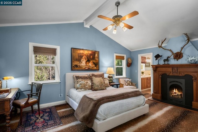 bedroom with ceiling fan, ensuite bath, ornamental molding, and vaulted ceiling with beams