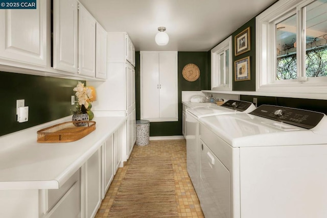 washroom with cabinets and separate washer and dryer