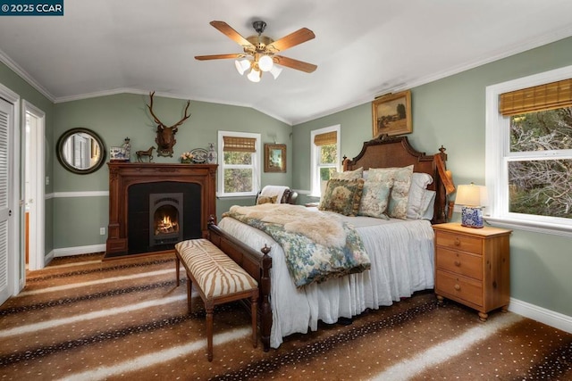 bedroom with crown molding, ceiling fan, lofted ceiling, and dark colored carpet