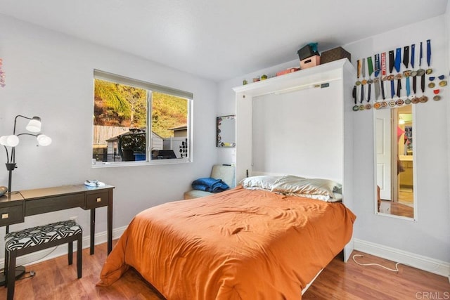 bedroom with hardwood / wood-style flooring