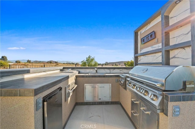 view of patio featuring an outdoor kitchen and a grill