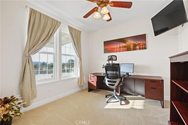 office with light carpet and ceiling fan