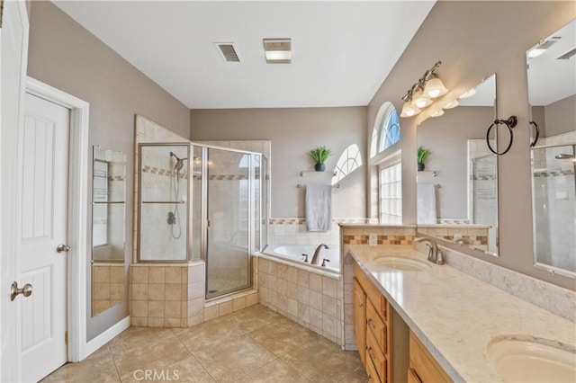 bathroom with vanity, tile patterned floors, and plus walk in shower