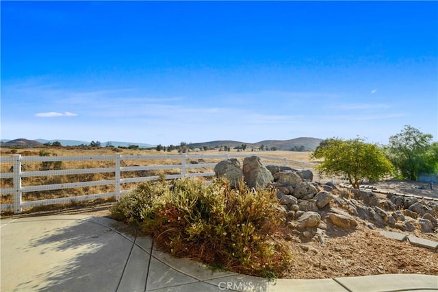 view of yard featuring a mountain view and a rural view