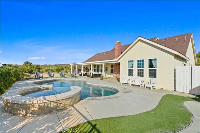 view of pool with an outdoor living space, an in ground hot tub, and a patio