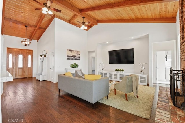 living room featuring beamed ceiling, dark hardwood / wood-style floors, and wooden ceiling