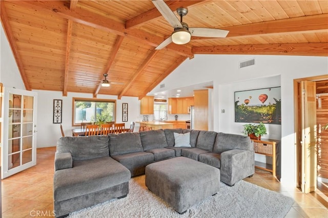 living room featuring light tile patterned flooring, ceiling fan, wood ceiling, and vaulted ceiling with beams