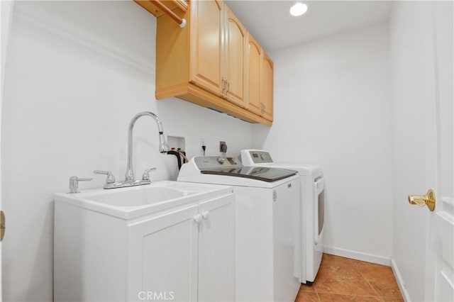 laundry area featuring cabinets, washing machine and dryer, and light tile patterned floors