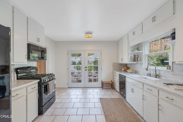 kitchen featuring french doors, sink, tasteful backsplash, black appliances, and white cabinets