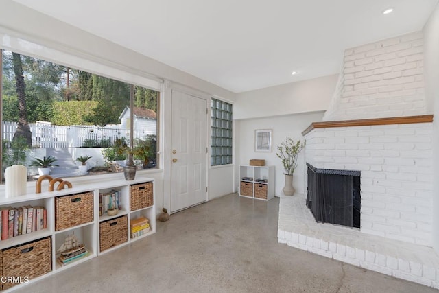 living room with a fireplace and concrete floors