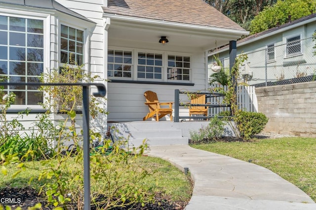 view of exterior entry with a porch