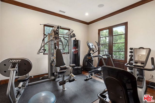 exercise room featuring crown molding