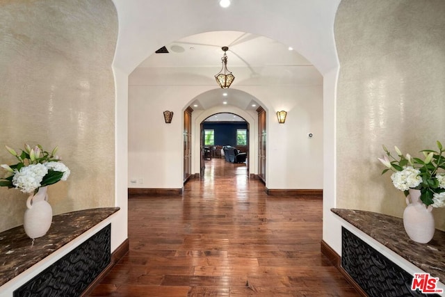 hallway with dark hardwood / wood-style flooring