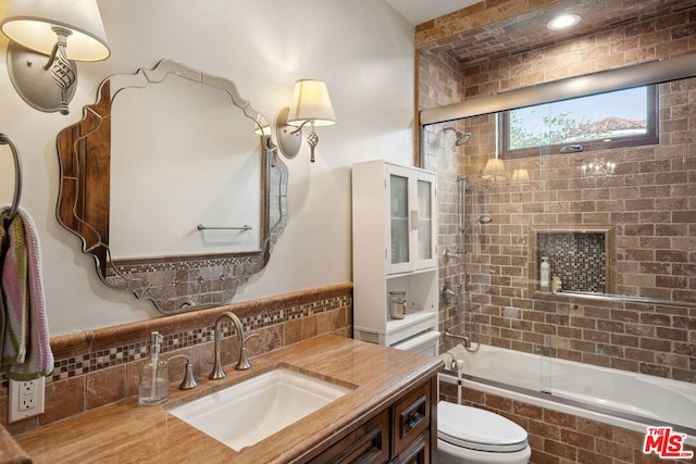 full bathroom with tasteful backsplash, enclosed tub / shower combo, vanity, and toilet