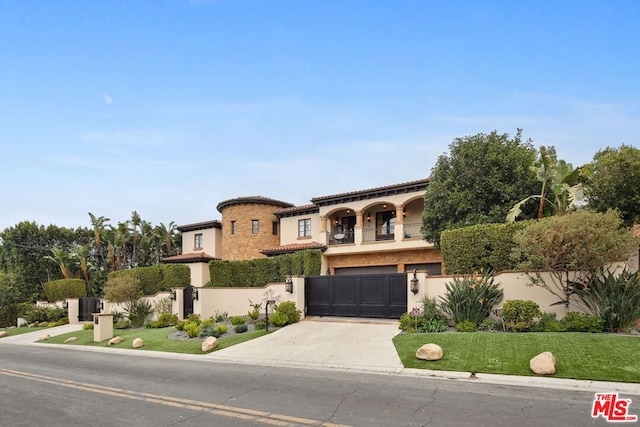 mediterranean / spanish-style home with a garage, a front lawn, and a balcony