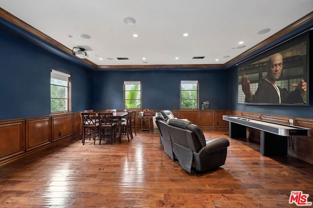 cinema room featuring ornamental molding and hardwood / wood-style floors