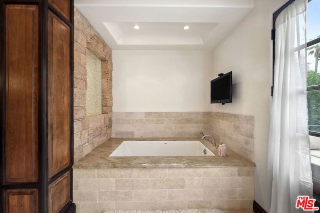 bathroom with a relaxing tiled tub